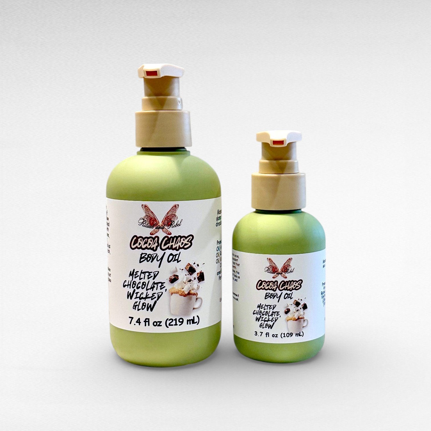 Cocoa Chaos Body Oil by Ritual and Rebel 7.4 and 3.7 fl oz green bottles with beige pumps white background