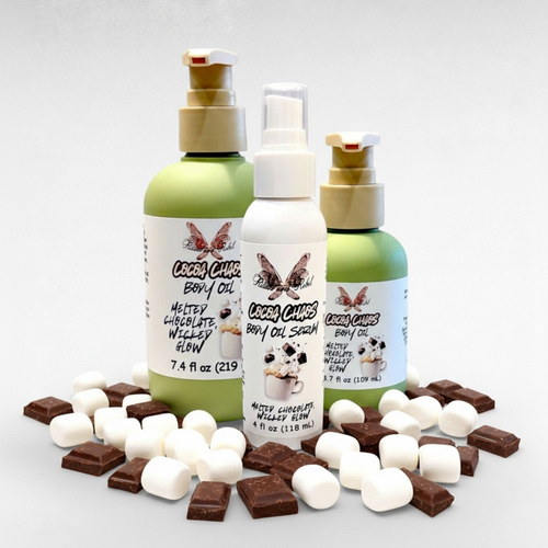 Cocoa Chaos Body Oil by Ritual and Rebel 2 green bottles 7.4 and 3.7 fl oz and 1 white bottle 4 fl oz with marshmallows and chocolate around bottom of jars