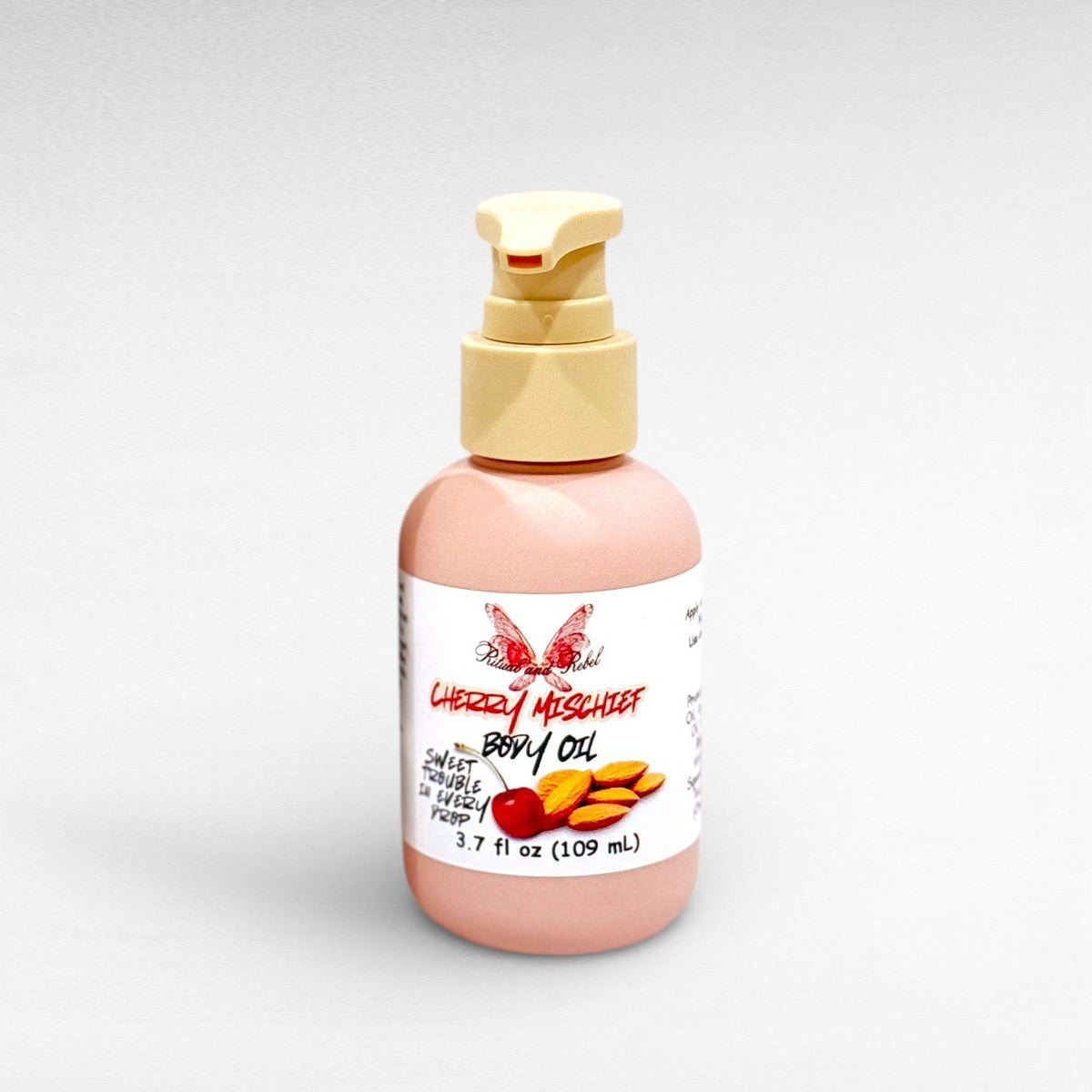 Cherry Mischief Body Oil by Ritual and Rebel pink bottle beige pimp 3.7 fl oz