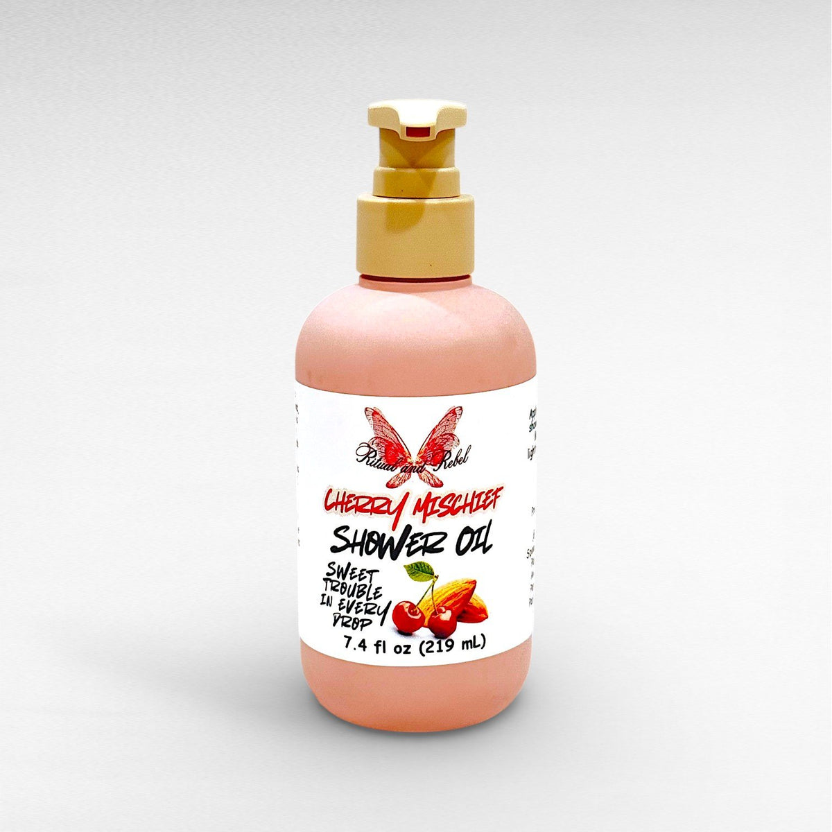 Cherry Mischief Body Oil by Ritual and Rebel pink bottle with beige pump 7.4 fl oz