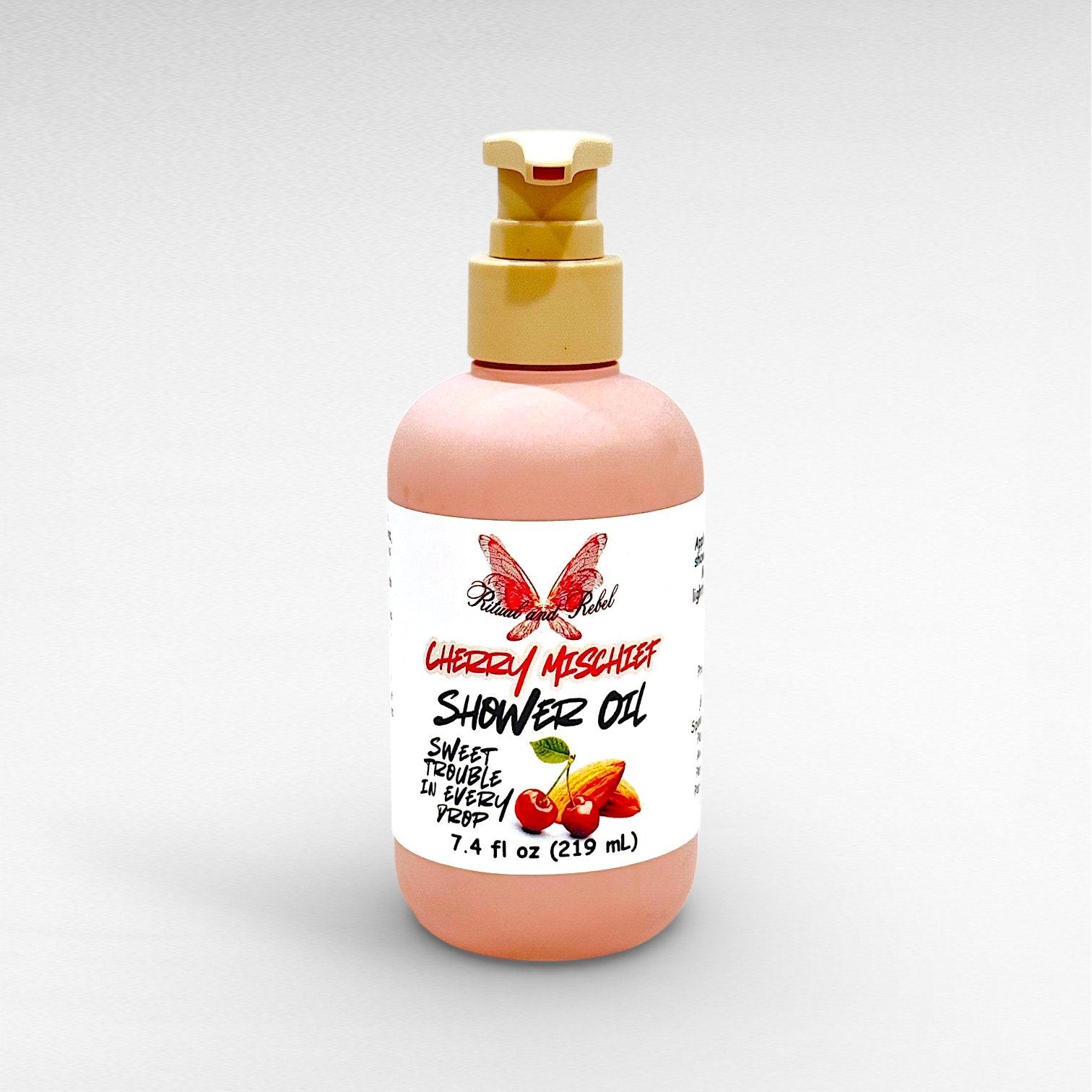 Cherry Mischief Body Oil by Ritual and Rebel pink bottle with beige pump 7.4 fl oz