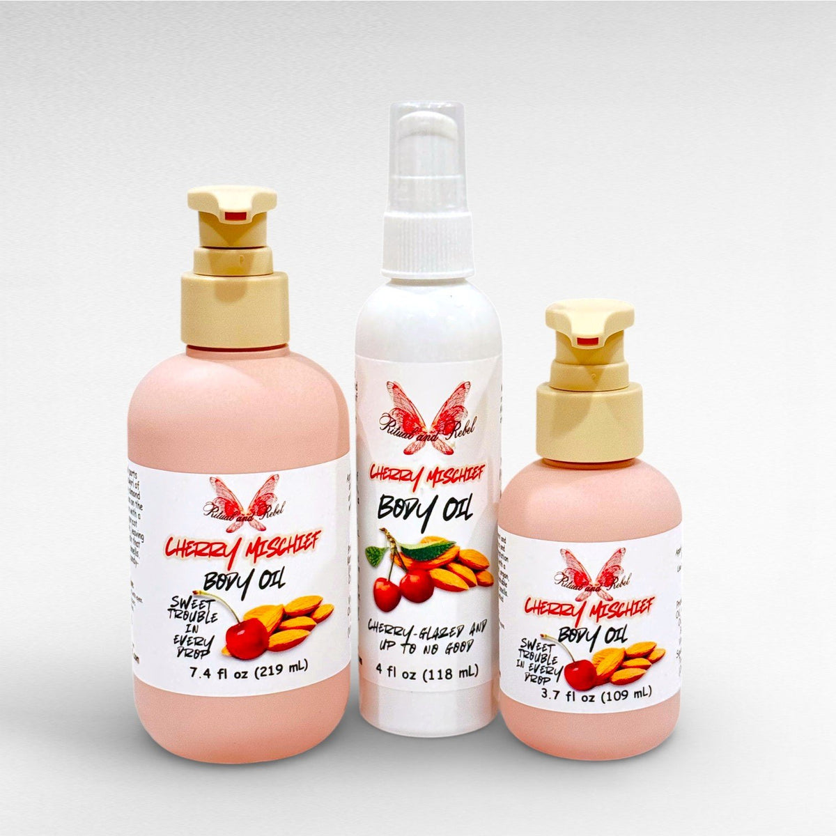 Cherry Mischief Body Oil by Ritual and Rebel 2 pink pump bottles with pumps and white bottle with serum pump