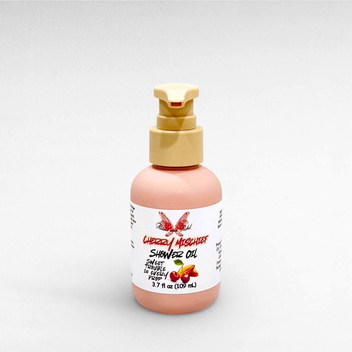 Cherry Mischief Shower Oil by Ritual and Rebel 3.7 fl oz pink bottle with beige pump