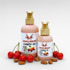 Cherry Mischief Shower Oil by Ritual and Rebel  pink bottles beige pumps cherries and almonds around base of bottles