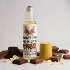 Chocolate Fever Lip Oil by Ritual and Rebel Roll-on lip oil with chocolate flavor packaging on a white background with chocolate pieces.