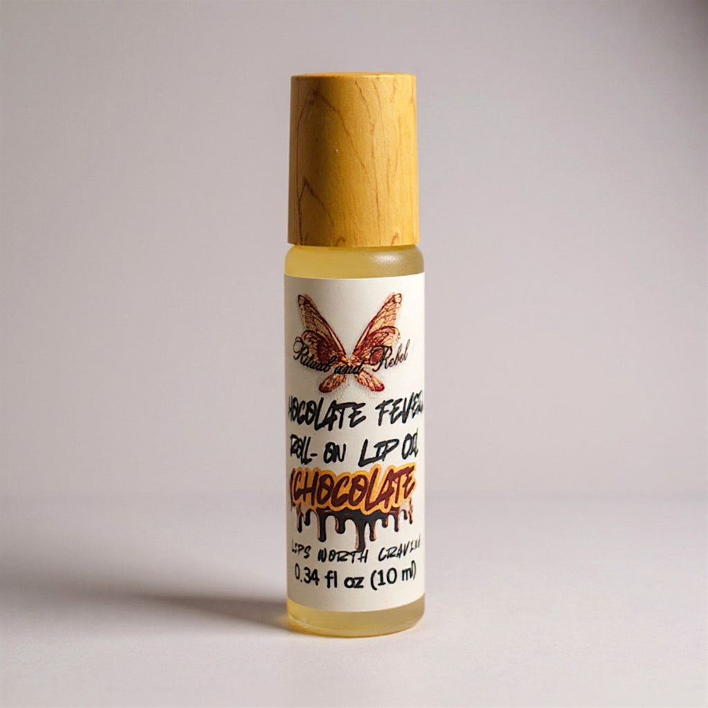 Chocolate Fever Roll-on lip oil by Ritual and Rebel glass bottle with bamboo wooden cap on a light gray background