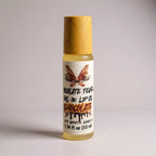 Chocolate Fever Roll-on lip oil by Ritual and Rebel glass bottle with bamboo wooden cap on a light gray background