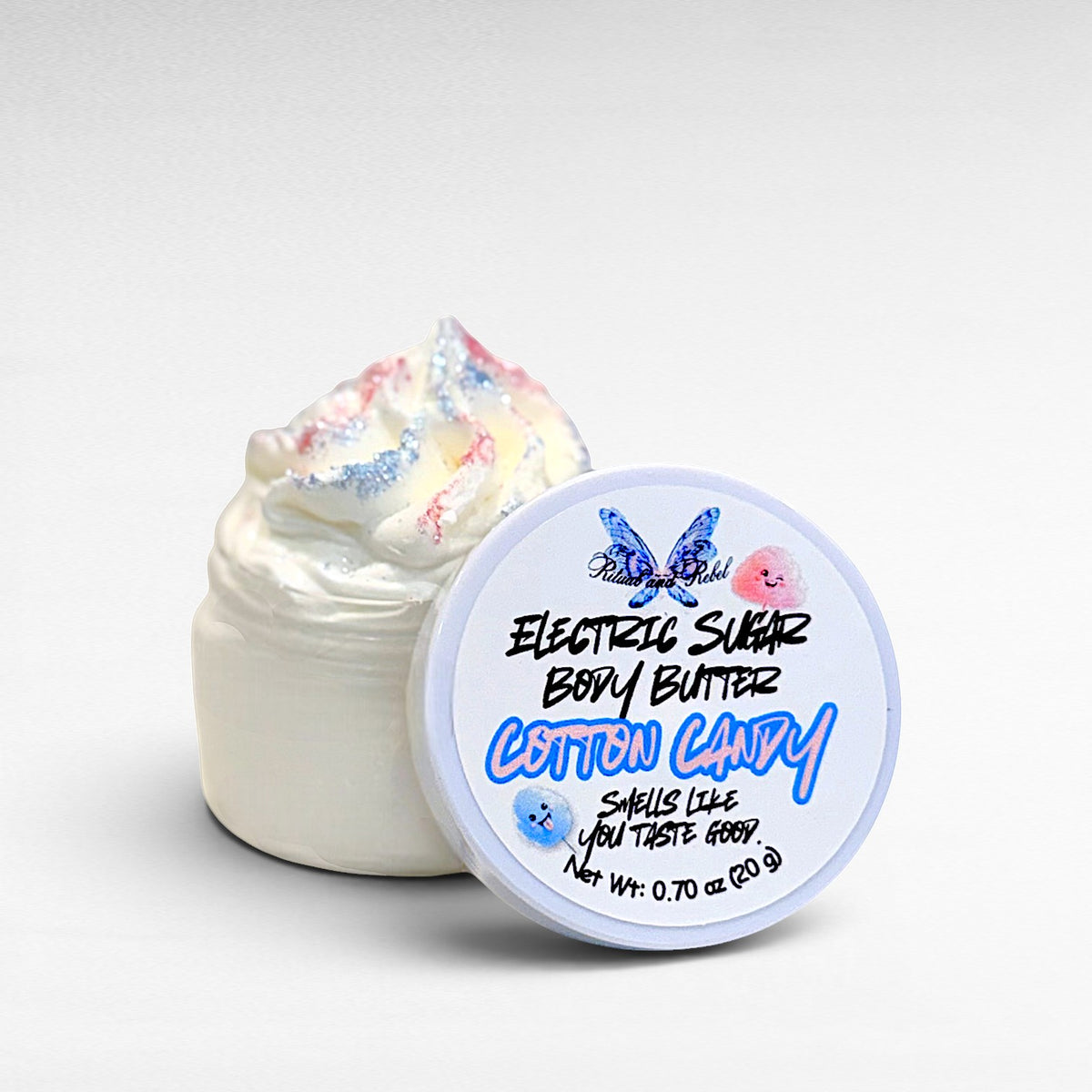 Electric Sugar Body Butter by Ritual and Rebel cream colored whipped body butter in clear plastic jar with pink and blue glitter mica on top and white round lid 0.70 oz