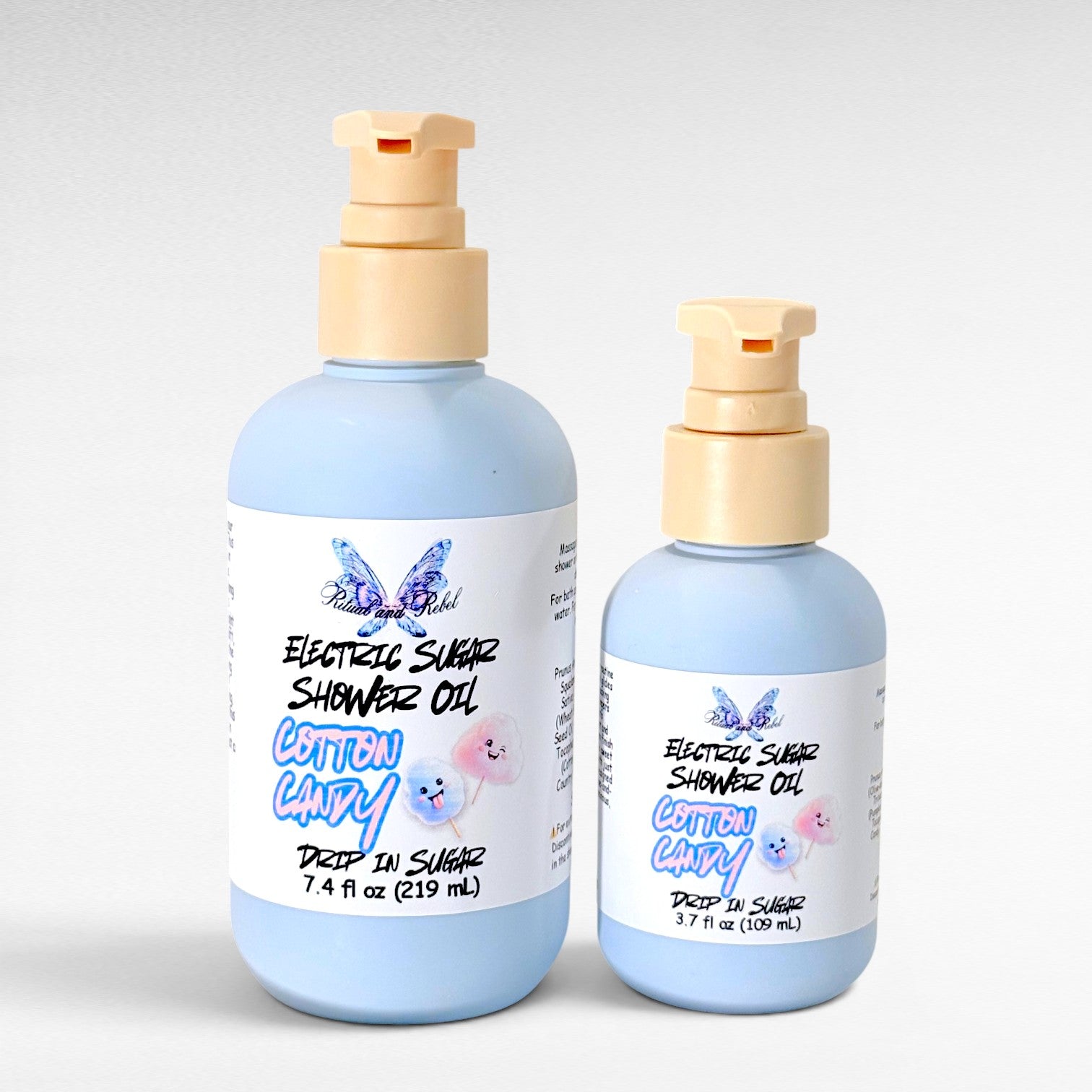 Two light blue bottles with pumps of Electric Sugar Cotton Candy scented Shower Oil from Ritual and Rebel on a white background 7.4 and 3.7 fl oz