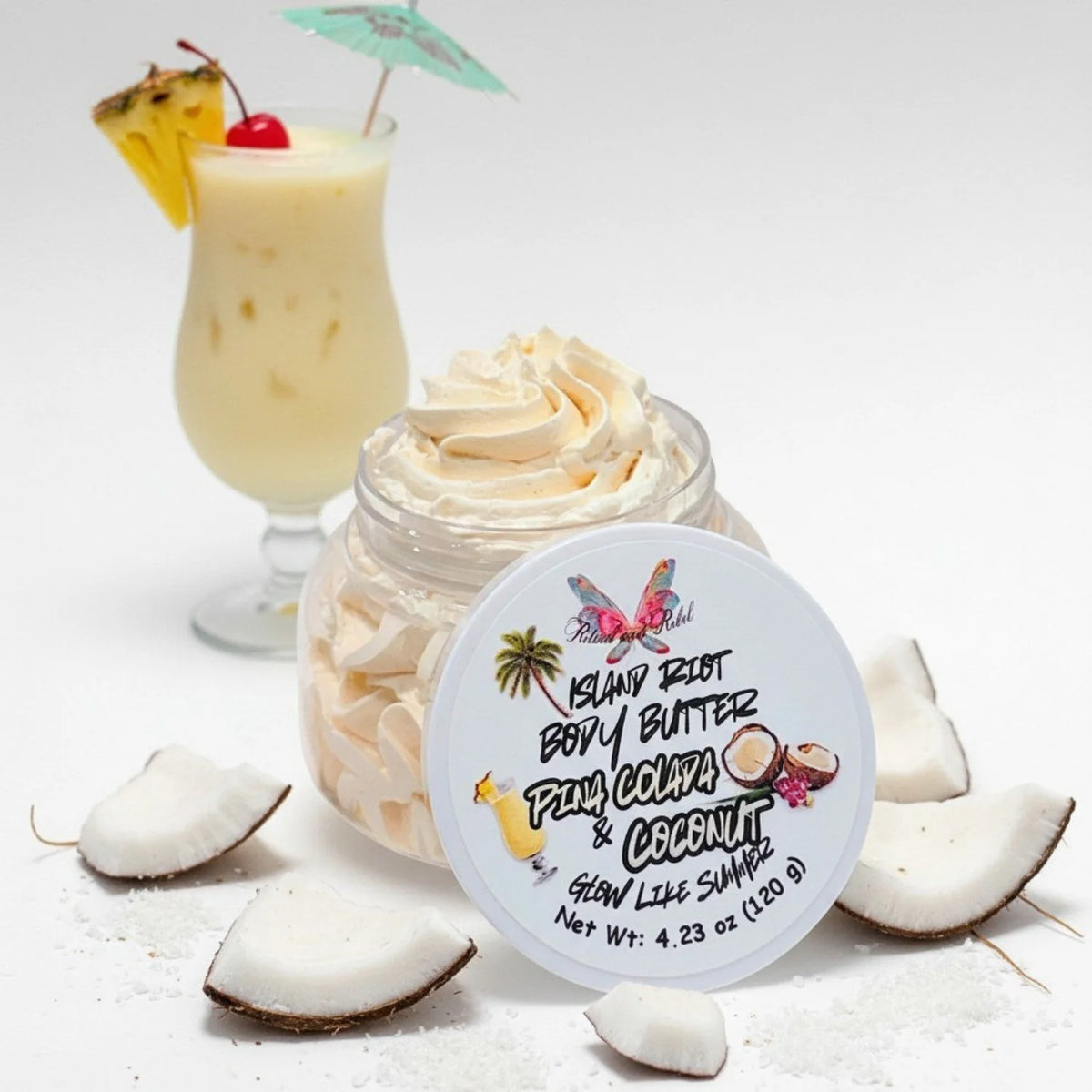 Island Riot Body Butter Pina Colada and Coconut clear plastic jar with whipped body butter and pina colada drink