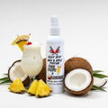 Island Riot Hair and Body Perfume by Ritual and Rebel Pina Colada and coconut 4.37 fl oz white plastic spray bottle with fruit around bottle 