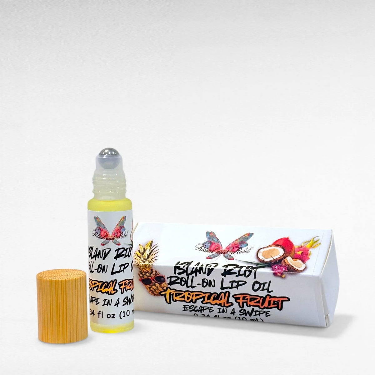 Island Riot Roll-On Lip Oil by Ritual and Rebel glass bottle with bamboo top white product box with label