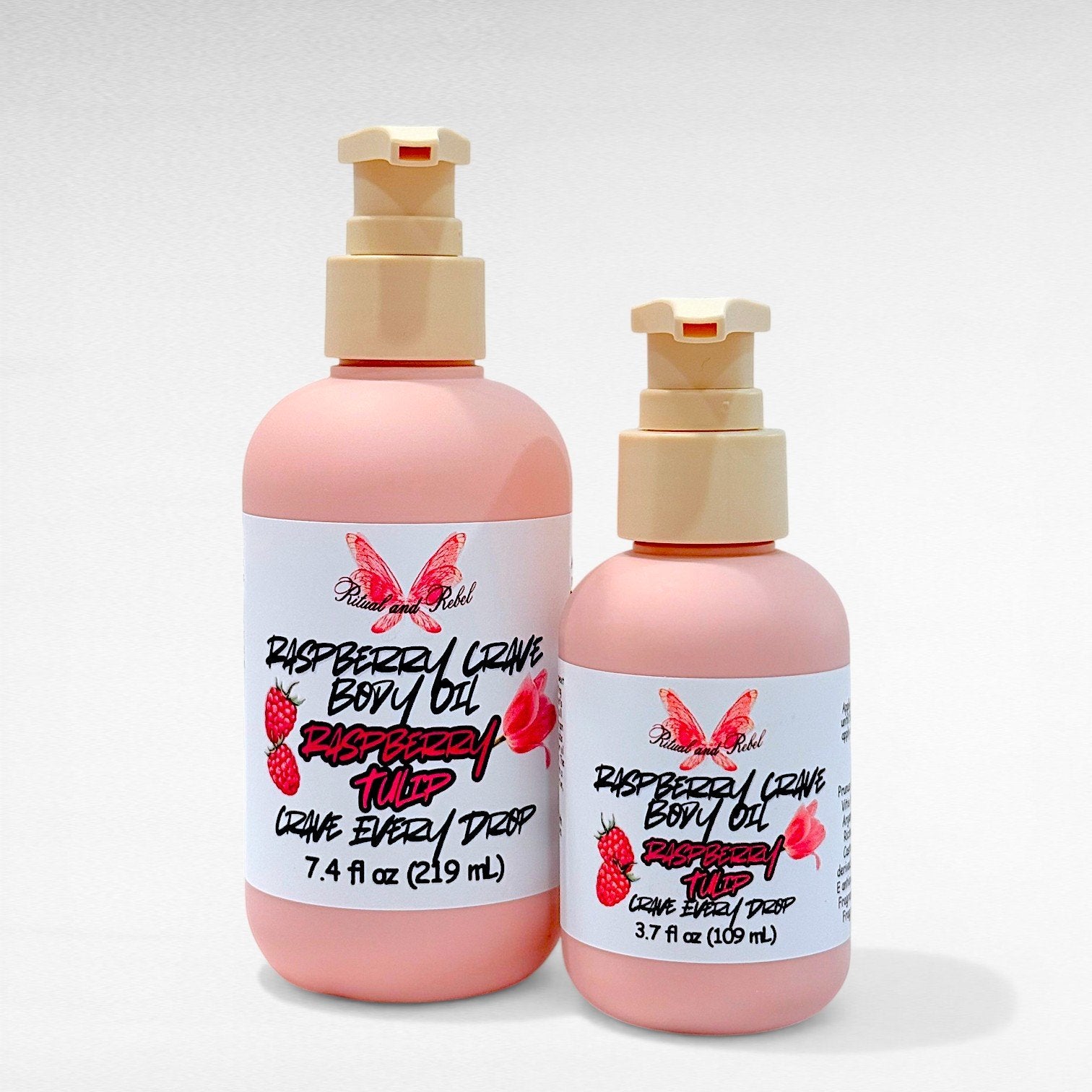 Raspberry Crave Body Oil by Ritual and Rebel two pink bottles with beige pumps 7.4 and 3.7 fl oz bottles