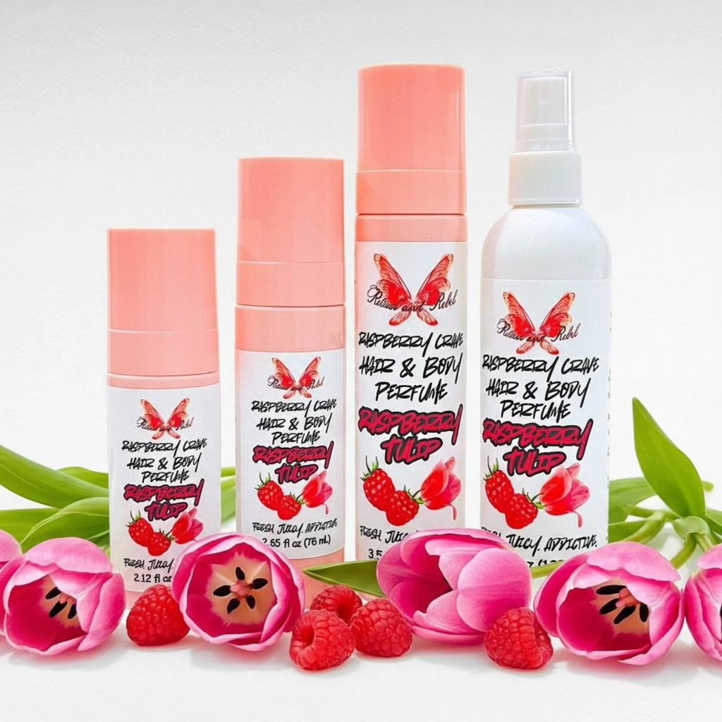 Raspberry Tulip hair and body perfume by Ritual and Rebel set of 3 pink spray bottles and 1 white spray bottle of various sizes with raspberries and tulips surrounding bottles
