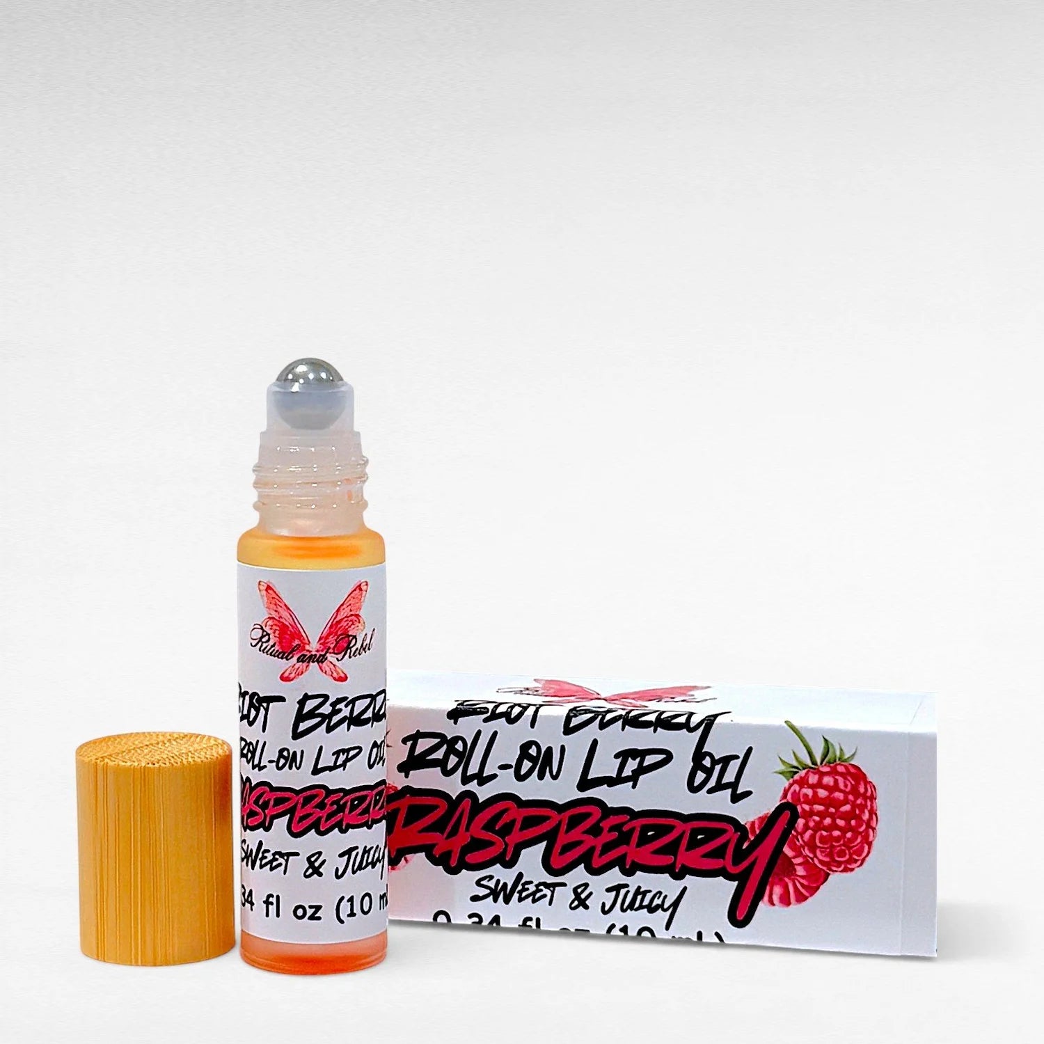 Riot Berry Roll On Lip Oil by Ritual and Rebel glass bottle with metal roll on ball with wood bamboo lid 10 ml with white product box 
