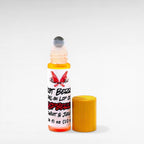 Riot Berry Roll On Lip Oil by Ritual and Rebel glass bottle with metal roll on ball with wood bamboo lid 10 ml