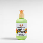 Ritual and Rebel Mango Crush Shower Oil in a light green bottle with a pump dispenser and tropical fruit label.