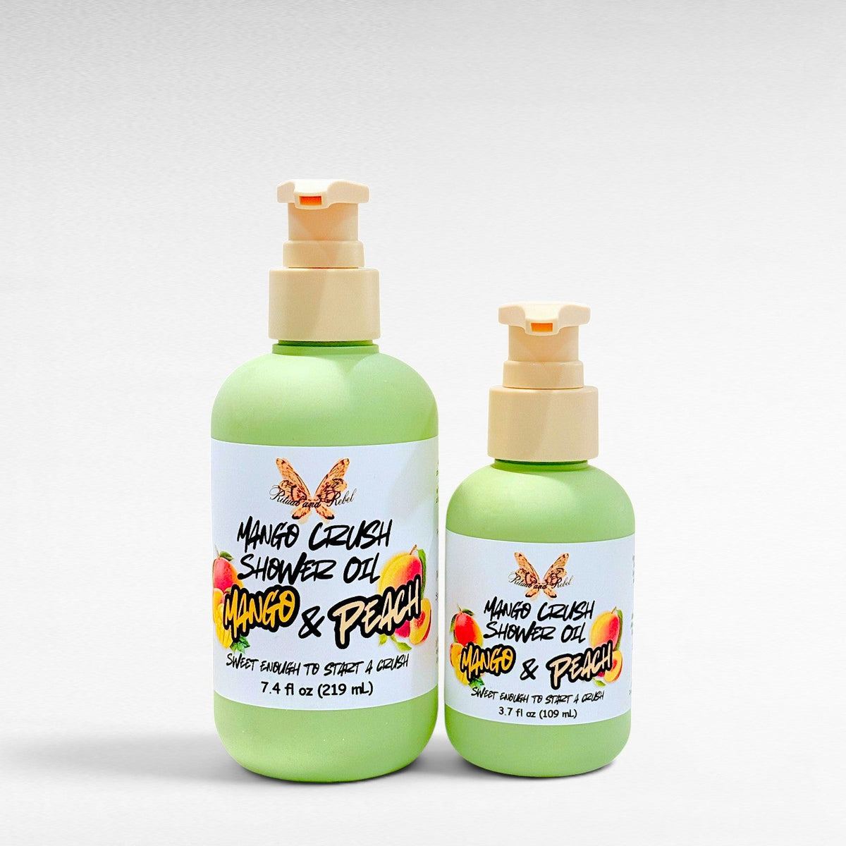 Ritual and Rebel Mango Crush Shower Oil bottles in two sizes with light green packaging and mango peach label art.