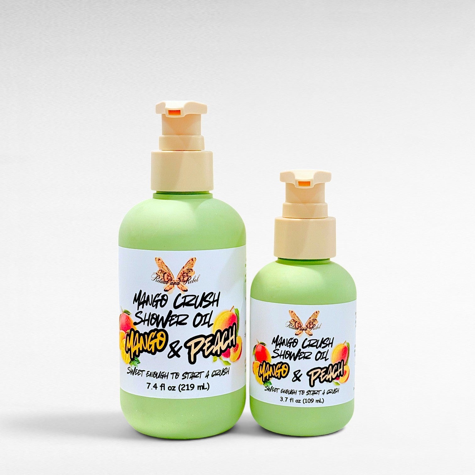 Ritual and Rebel Mango Crush Shower Oil bottles in two sizes with light green packaging and mango peach label art.