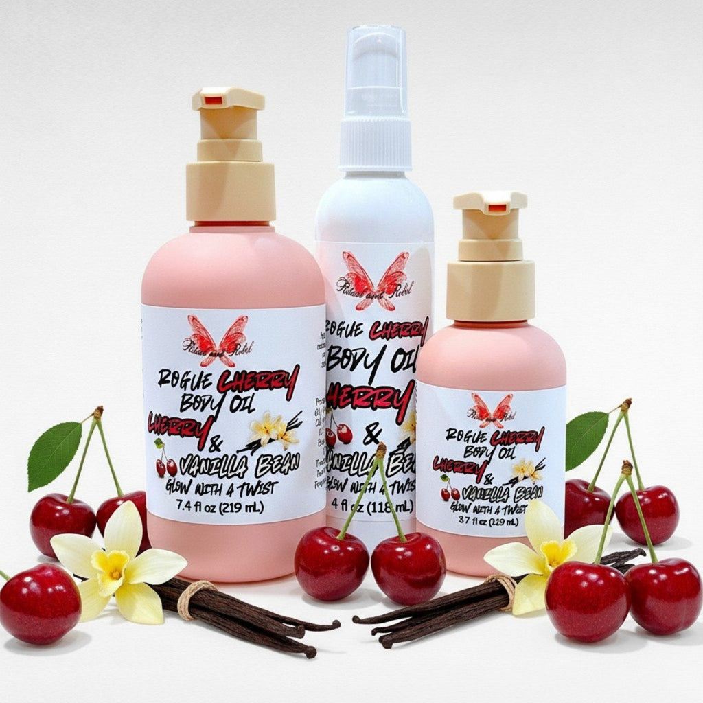 Rogue Cherry Body Oil by Ritual and Rebel 2 pink bottles and 1 white bottle with pumps and cherries and vanilla beans surrounding it 