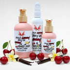 Rogue Cherry Body Oil by Ritual and Rebel 2 pink bottles and 1 white bottle with pumps and cherries and vanilla beans surrounding it 