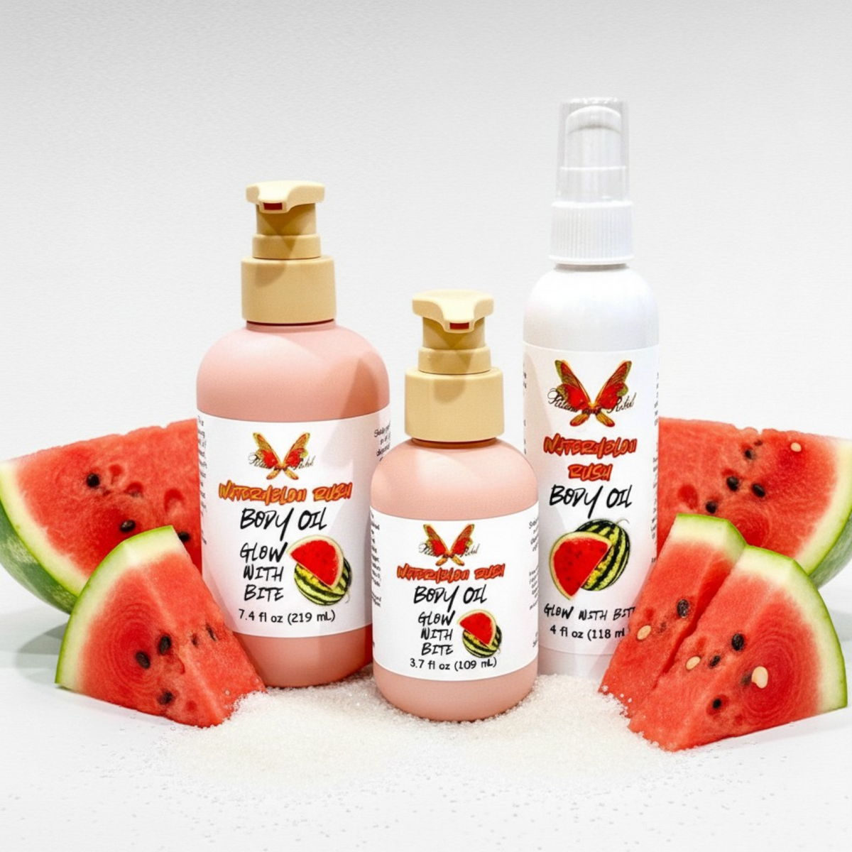 Watermelon Rush Body Oil by Ritual and Rebel 2 pink bottles with beige pumps and 1 white bottle with serum pump watermelon with sugar around bottles